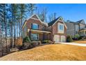 Brick home on a hill, featuring a well-maintained lawn, a covered porch, and a two-car garage at 337 Ellis Preserve Sw Ln, Marietta, GA 30064