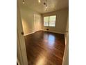 Cozy bedroom featuring hardwood floors, natural light, and a convenient closet at 6625 Starling Sw Pl, Mableton, GA 30126