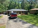 Ranch-style home with a driveway and a well-maintained lawn at 6625 Starling Sw Pl, Mableton, GA 30126
