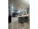 Well-equipped kitchen with stainless appliances, grey cabinets, and bar seating at 6625 Starling Sw Pl, Mableton, GA 30126