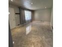 Bright living room features large-format tile flooring, recessed lights, and abundant natural light at 6625 Starling Sw Pl, Mableton, GA 30126