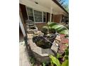 Exterior view of a quaint pond with stone features and lush greenery at 6625 Starling Sw Pl, Mableton, GA 30126