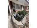 Charming stone water fountain with a pond, adding tranquility to the home's exterior at 6625 Starling Sw Pl, Mableton, GA 30126