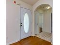 Bright entryway featuring tile flooring, arched doorways, and a front door with decorative glass at 6715 Biscayne Blvd, Rex, GA 30273