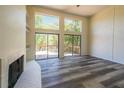 Spacious living room with fireplace, deck access, and hardwood floors at 1107 Riverbend Club Se Dr, Atlanta, GA 30339