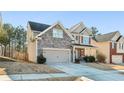 Two-story house with stone accents and a large front yard at 1537 Balvaird Dr, Lawrenceville, GA 30045