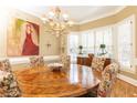 Formal dining room featuring a large round table and chandelier at 63 Habersham Cove Nw Ln, Atlanta, GA 30305