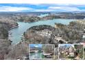 Lakefront homes with private docks surrounded by lush trees, offering a serene lifestyle, captured in an aerial view at 2843 Merritt Dr, Buford, GA 30518