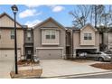 Modern taupe townhome with two-car garage and landscaping at 360 Rockfern Ct, Lilburn, GA 30047