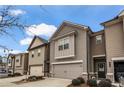 Tan townhome with 2-car garage, and a large window above at 360 Rockfern Ct, Lilburn, GA 30047