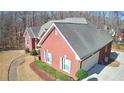 Brick home with attached garage and landscaped yard at 3648 Clark Hill Way, Buford, GA 30519