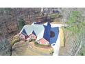 Large brick home with a spacious backyard and driveway at 3648 Clark Hill Way, Buford, GA 30519