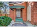 Front entrance with a green awning and security door at 825 E Lake Dr, Decatur, GA 30030