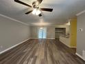 Inviting living room features modern flooring, ceiling fan, and seamlessly connects to the dining area and kitchen at 22 Cardinal Ln, Jonesboro, GA 30238