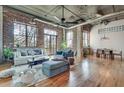 Spacious living area boasts exposed brick, hardwood floors, and large windows at 3235 Roswell Rd # 709, Atlanta, GA 30305