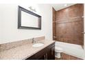 Bathroom with granite vanity, tiled shower, and updated fixtures at 333 Nelson Sw St # 404, Atlanta, GA 30313