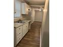 Kitchen with white cabinets and laminate countertops at 1228 Elizabeth Sw Ave, Atlanta, GA 30310