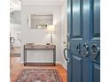 Bright entryway with console table, mirror, and rug at 439 Mountain View Ln, Woodstock, GA 30188