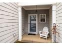 Inviting front porch with white rocker and entry door at 439 Mountain View Ln, Woodstock, GA 30188