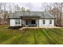 Back of the house with covered patio and seating area at 25 Water Oak Trl, Covington, GA 30014