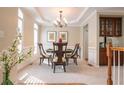 Cozy dining room featuring neutral walls, stylish chandelier, and elegant table setting at 342 Holbrook Rd, Smyrna, GA 30082