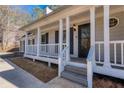 White columns and railings enhance the home's curb appeal at 4620 Sammy Dr, Powder Springs, GA 30127