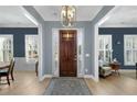 Bright and spacious entryway with hardwood floors and a view into the living and dining areas at 100 Kendemere Pointe, Roswell, GA 30075