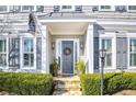 Gray front door with a wreath, stone steps, and landscaping at 100 Kendemere Pointe, Roswell, GA 30075