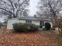 Rear of the home with a small yard and some vegetation visible at 3453 Woodlawn Cir, Tucker, GA 30084