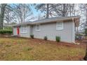 Well-maintained single-story home featuring lush green lawn and beautiful landscaping at 1658 Hollyhock Ter, Decatur, GA 30032