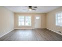 Inviting living room with wood-look flooring and plenty of natural light from large windows at 1658 Hollyhock Ter, Decatur, GA 30032