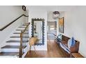 Bright entryway with hardwood floors, staircase, and bench at 4290 Valley Trail Se Dr, Atlanta, GA 30339