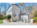White farmhouse style home with a detached garage at 4290 Valley Trail Se Dr, Atlanta, GA 30339