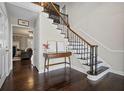 Foyer with hardwood floors, staircase with iron spindles, and a view into the living room at 5422 Hill Sw Rd, Powder Springs, GA 30127