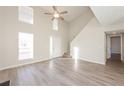 Spacious living room with hardwood floors, high ceiling, and natural light at 5541 Panola Pl, Lithonia, GA 30058