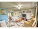Bright living room with comfy seating and a large TV at 981 Meadowbrook Nw Ln, Conyers, GA 30012