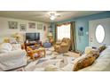 Living room featuring light walls, comfy sofas, and a large TV at 981 Meadowbrook Nw Ln, Conyers, GA 30012