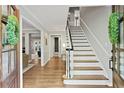 Bright and airy entryway with hardwood floors and elegant staircase at 1130 Edgewater Dr, Atlanta, GA 30328