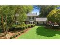 Beautiful two-story home with a well-manicured lawn and mature landscaping at 1130 Edgewater Dr, Atlanta, GA 30328