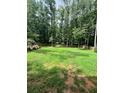 Large grassy backyard with wooden fence at 1221 Martin Nash Sw Rd, Lilburn, GA 30047