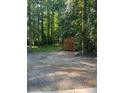 Backyard with shed and wooded area at 1221 Martin Nash Sw Rd, Lilburn, GA 30047