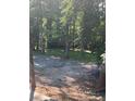 Wooded backyard with a gravel area at 1221 Martin Nash Sw Rd, Lilburn, GA 30047