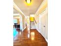 Hardwood floor entry way with view of staircase and dining room at 3026 Bridge Walk Dr, Lawrenceville, GA 30044