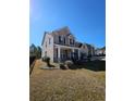 Side view of a brick two-story home with a well-kept lawn and black fencing around the property at 3026 Bridge Walk Dr, Lawrenceville, GA 30044