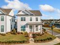 Charming two-story white home with well-maintained landscaping and a covered front porch at 1026 Cagle Creek Overlook, Canton, GA 30115