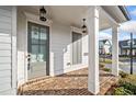 Charming front porch with brick floor, white columns, and an inviting front door at 1026 Cagle Creek Overlook, Canton, GA 30115