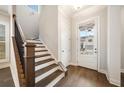 Staircase with dark wood railings and hardwood floors at 1026 Cagle Creek Overlook Trl, Canton, GA 30114