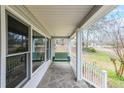 Inviting front porch featuring a charming porch swing and stone flooring at 381 Mount Moriah Rd, Auburn, GA 30011