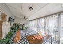 Relaxing sunroom with patterned floors, plants, and curtains for an airy feel at 381 Mount Moriah Rd, Auburn, GA 30011