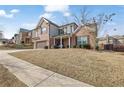 Two story home featuring brick and siding, an attached two car garage, and a covered front porch at 1202 Ida Woods Ln, Lawrenceville, GA 30045